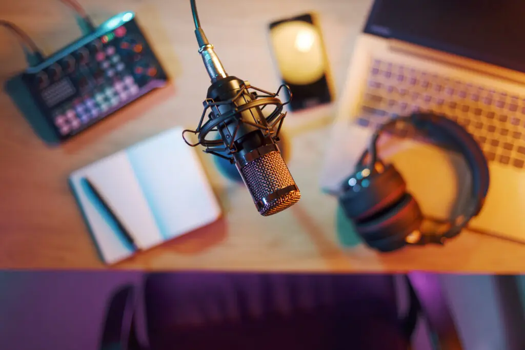 Podcast setup with microphone and laptop.